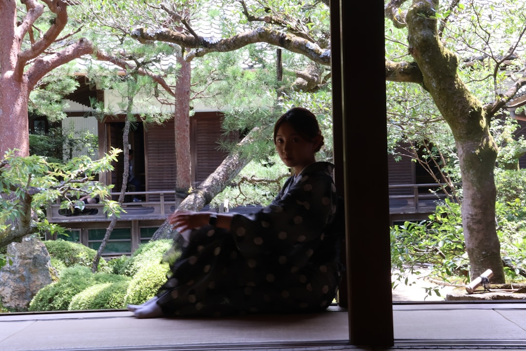 a-woman-sitting-on-the-floor-in-front-of-a-window-upvnepp2-q8